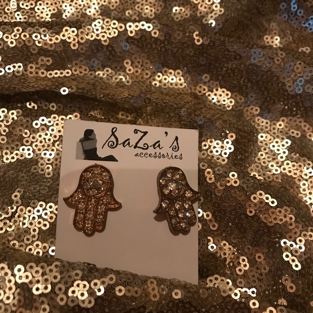 Gold and crystal stone hamsa earrings. Boutique